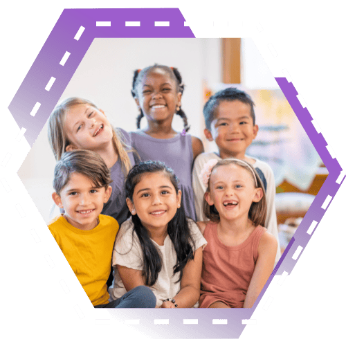children smiling in a classroom